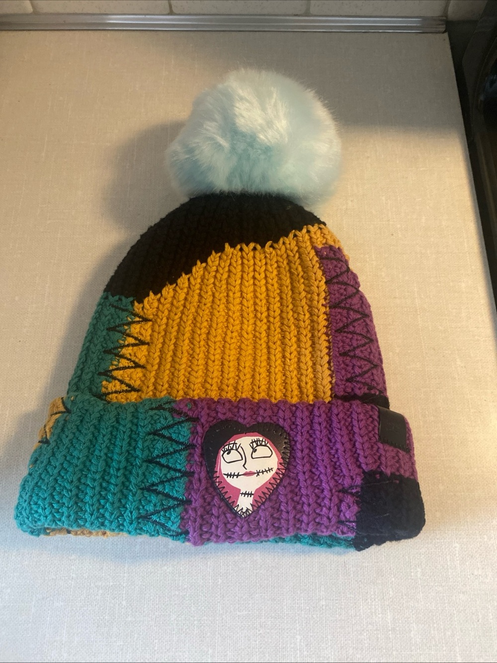 Love Your Melon Disney Sally Patchwork Multicolor Beanie Pom Pom Hat